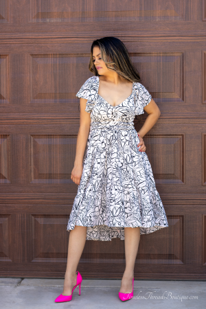 "Boho White Floral Midi Dress from Timeless Threads Boutique featuring a flowing white fabric with delicate floral prints, designed for a chic and effortless bohemian look."