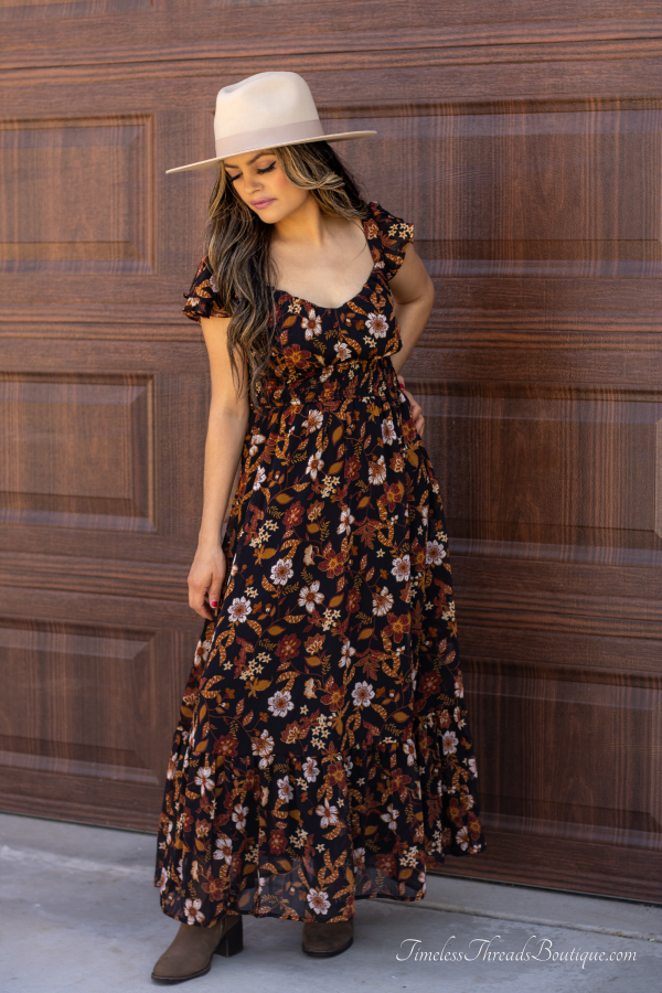 "Isabella Floral Ruffle Back-Tie Midi Dress featuring vibrant multi-colored floral prints, ruffle short sleeves, and a back-tie detail for an elegant and stylish look."