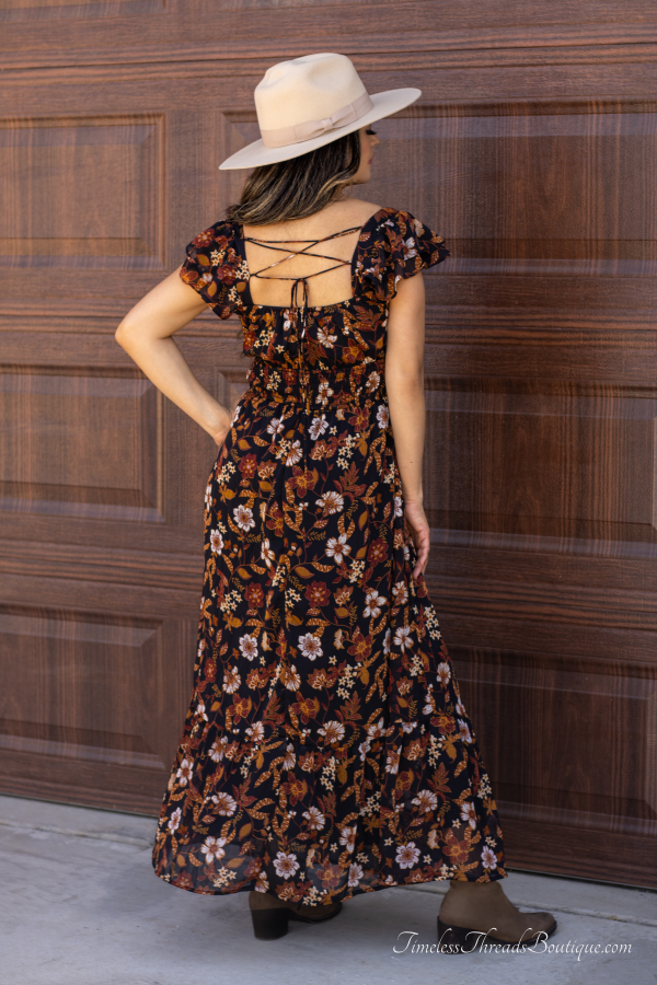 "Isabella Floral Ruffle Back-Tie Midi Dress featuring vibrant multi-colored floral prints, ruffle short sleeves, and a back-tie detail for an elegant and stylish look."