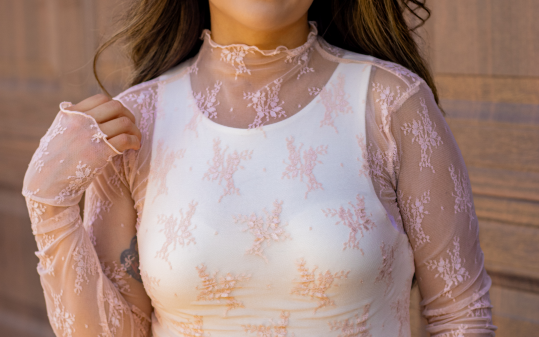 Grace Blush Lace Mock Neck Top with long sleeves and thumb holes, featuring delicate lace details and a soft blush color, perfect for adding a feminine touch to any outfit.