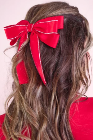 Crimson Charm Red Hair Bow featuring a vibrant red color and smooth fabric, attached to a secure clip for easy styling and a stylish touch to any hairstyle.