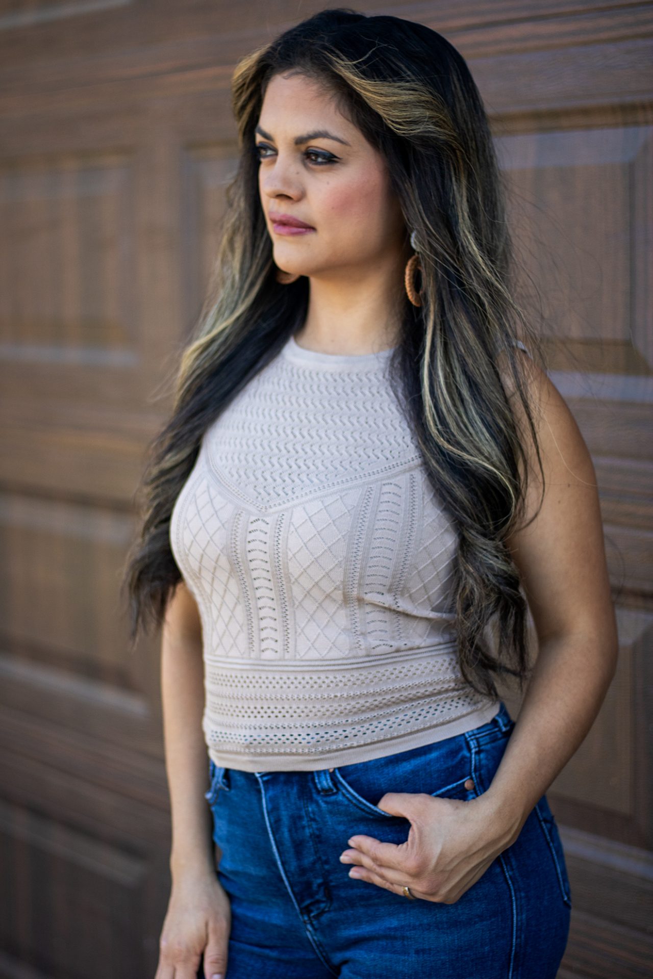 Latte-colored fine gauge tank with pointelle detailing and mixed knit textures displayed on a hanger.