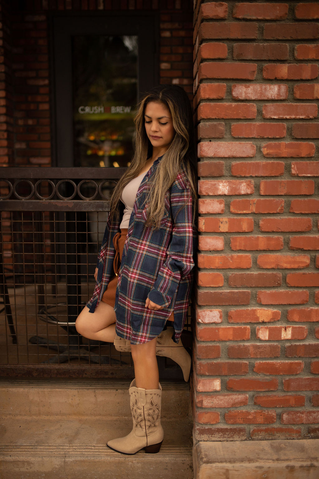 Blue and red plaid oversized tunic top with long sleeves and a relaxed button-front design shown worn for a casual, comfortable look.