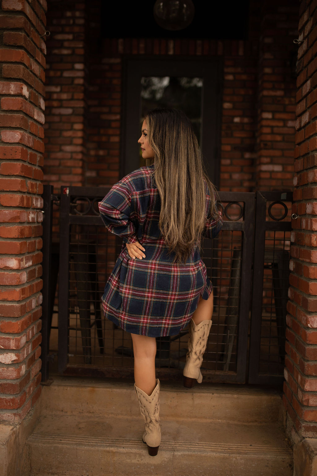 Blue and red plaid oversized tunic top with long sleeves and a relaxed button-front design shown worn for a casual, comfortable look.