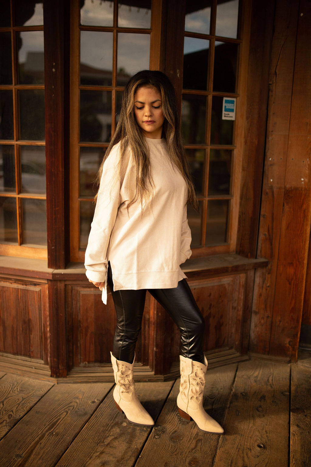 Taupe vintage-washed corded pullover with ribbed texture, crew neckline, and hi-lo hem with side slits shown in natural outdoor lighting.