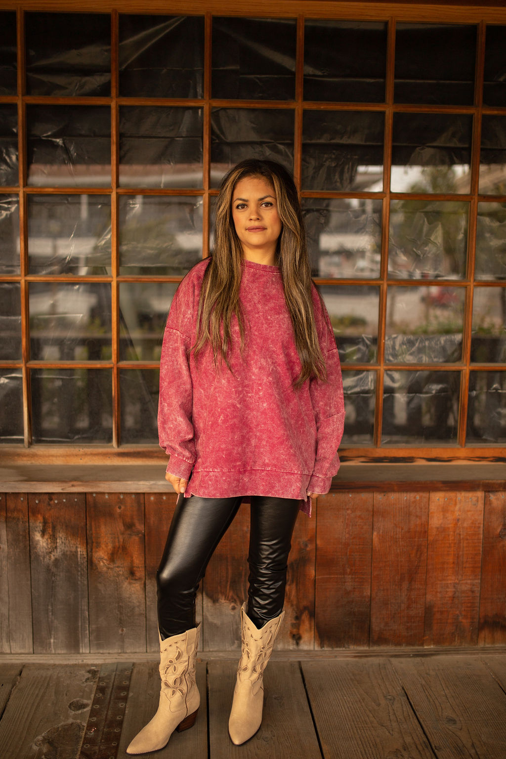 Maroon vintage-washed corded pullover with ribbed texture, crew neckline, and hi-lo hem with side slits displayed in natural outdoor lighting.