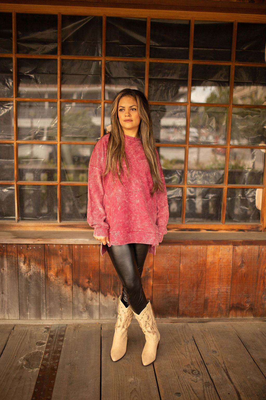 Maroon vintage-washed corded pullover with ribbed texture, crew neckline, and hi-lo hem with side slits displayed in natural outdoor lighting.