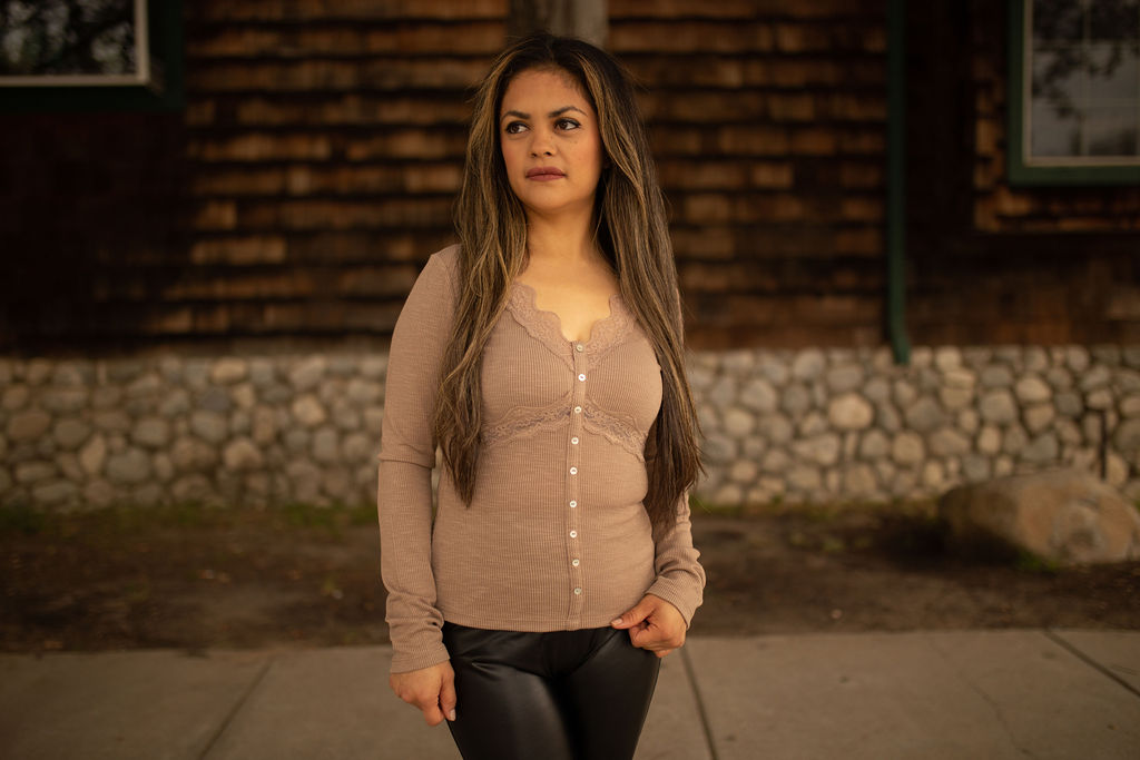 Taupe ribbed long sleeve top with lace trim and front buttons, displayed outdoors in natural lighting.