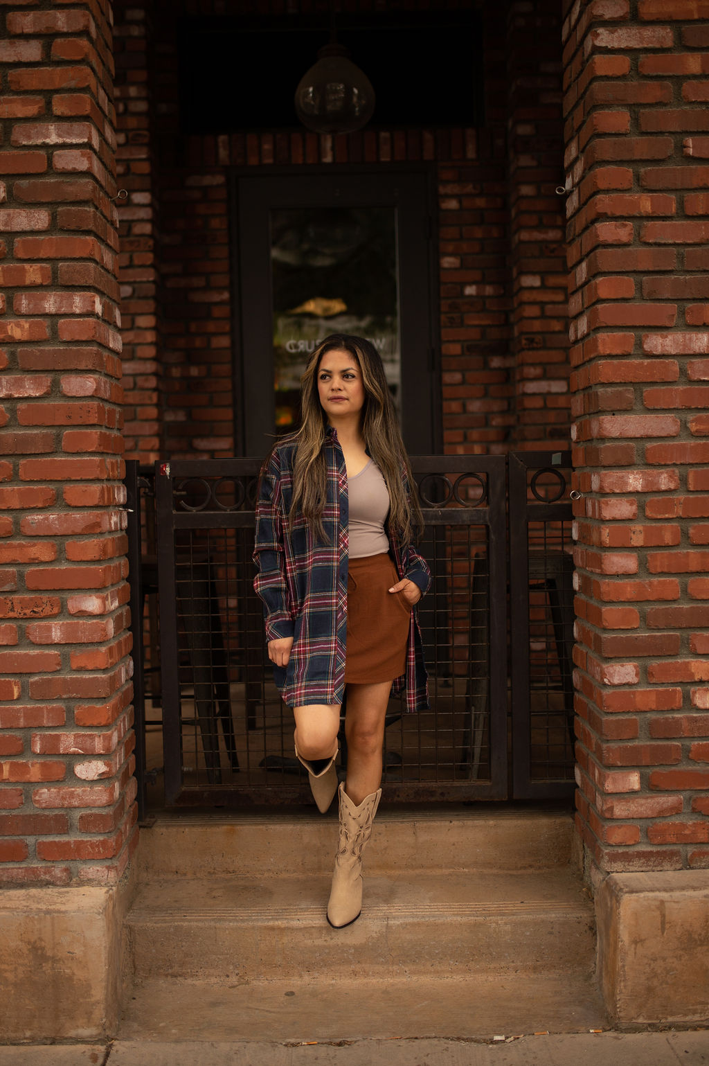 Blue and red plaid oversized tunic top with long sleeves and a relaxed button-front design shown worn for a casual, comfortable look.