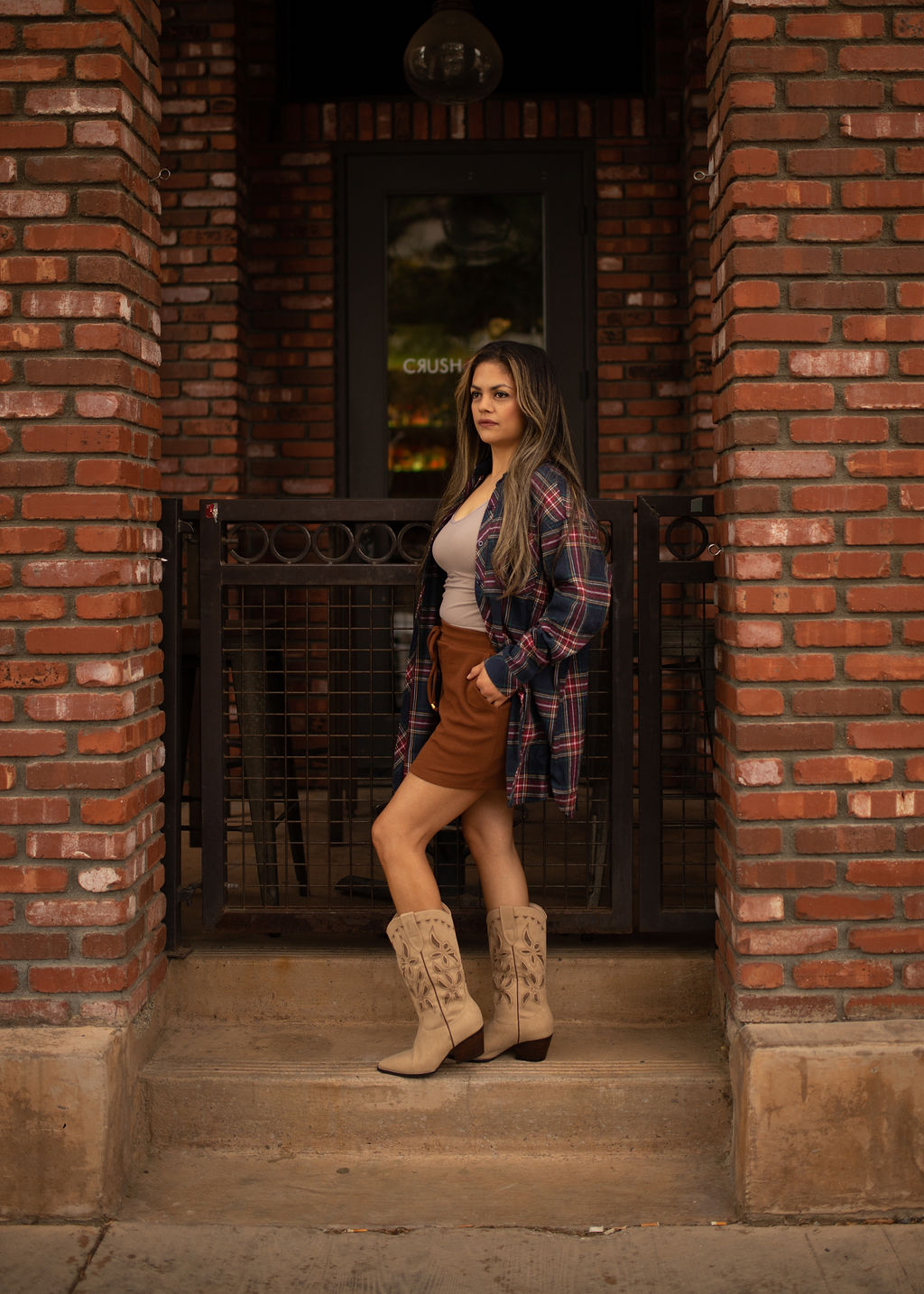 Blue and red plaid oversized tunic top with long sleeves and a relaxed button-front design shown worn for a casual, comfortable look.